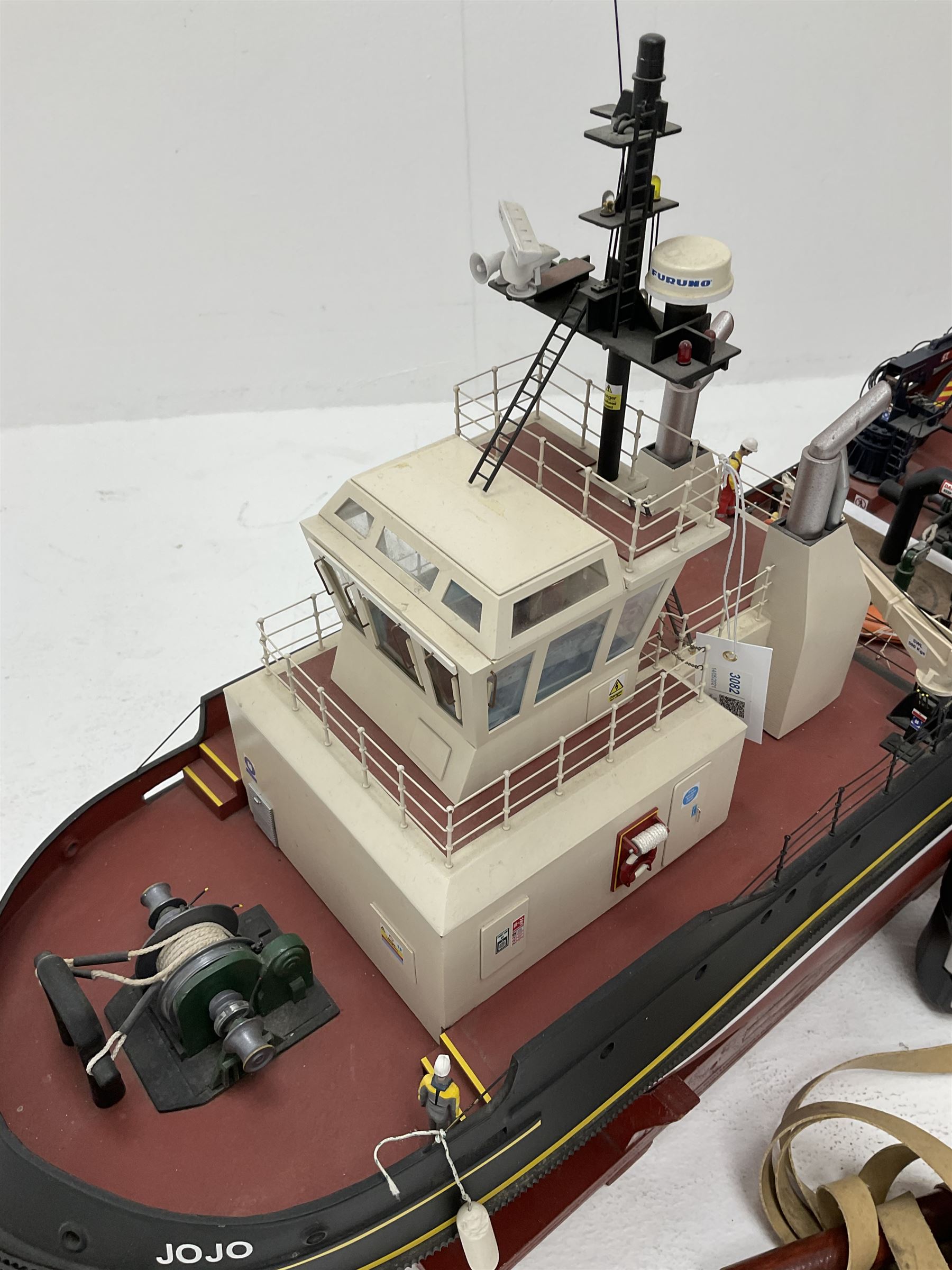 24-Volt radio controlled model of the American tug boat 'Jo-Jo' with full range of deck fittings, transmitter, remote control, receivers and two launching straps, displayed on wooden stand L103cm