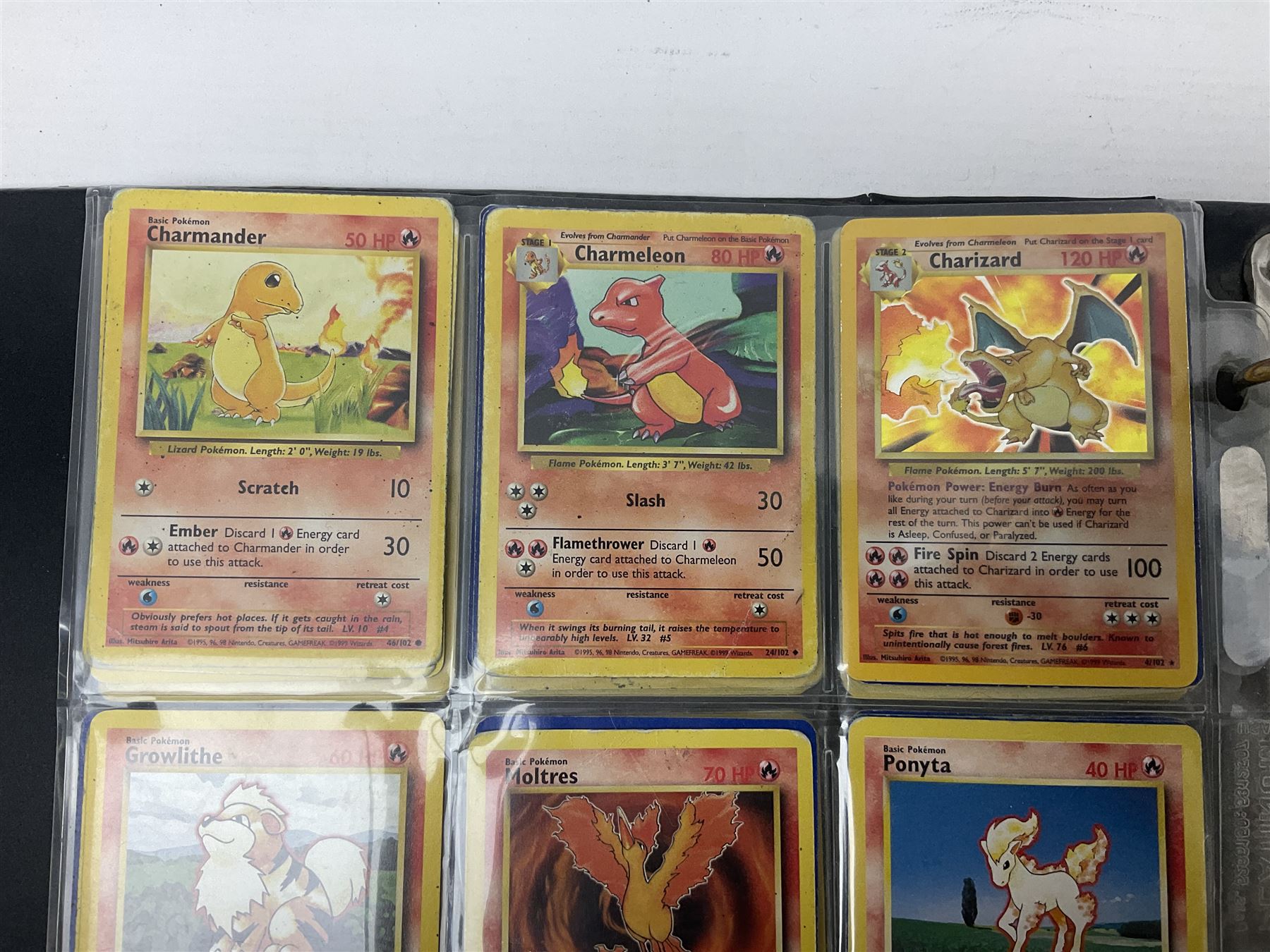 Collection of Pokemon trading cards, mostly 1999 Wizards Pokemon cards to include holo Charizard 4/102, first edition holo Machamp 8/102, further holographic cards; Dark Flareon 35/82 and Dark Vaporeon 45/82, cards from themed sets and 4th edition prints; 1998 Electronic Pokédex with cardboard boxes for themed decks Blackout, Overgrowth and Power Reserve Jungle, along with a large quantity of energy and trainer cards 