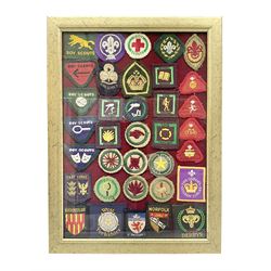 Boy Scout Interest; framed collection of Boy Scouts cloth insignias, to include badges from East Yorkshire, Northumberland, West Yorkshire, Devon, Norfolk and Derby, thirty four badges in total  