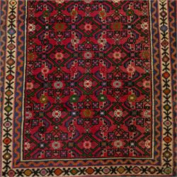 North West Persian runner, red field decorated with repeating herati motifs and small flowerheads, enclosed by cream main border with stylised floral motifs and narrow guard borders, fringed ends