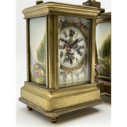 Brass and bevelled glass cased carriage timepiece clock and barometer, with painted porcelain panels depicting floral garlands and country scenes, the timepiece with Roman dial and single train driven movement, aneroid barometer with Arabic register, central pillar supporting handle