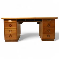 Mid 20th century teak twin pedestal partners desk, rectangular top with rounded corners with integral frieze storage shelf, above  pedestals each fitted with three drawers, recessed circular pull handles, cupboard doors fitted to the opposing side on concealed plinth bases