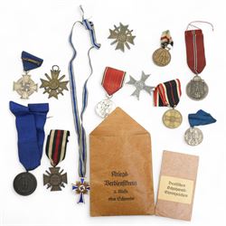 German Third Reich War Merit Cross, 1st class with swords, clasp marked '65', another with...