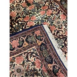 Persian Zanjan rug, pale ground and decorated with floral Herati motifs, decorated all over with flower heads, repeating scrolled guarded border