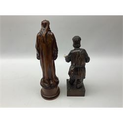 Carved beech and ivory model of a religious figure, after Franz Zelezny, donning robe with laurel crown standing upon turned base, signed 'F. Zelezny 1898', together with another beech and ivory figure of a man donning rags and missing a shoe, standing with his hand upon a walking stick upon carved square base, tallest H34cm