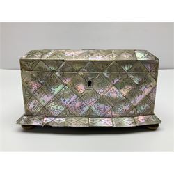 Victorian mother of pearl tea caddy, of rectangular bow-fronted form, the body with floral, bird and geometric engraved mother of pearl panels, white metal shield plaque to the cover inscribed with the initials G.J.A and similar escutcheon, the two division interior with ivory edging and two panelled mother of pearl lids, on four vegetable ivory bun feet L20cm, together with a similar style mother of pearl card case (2) This item has been registered for sale under Section 10 of the APHA Ivory Act