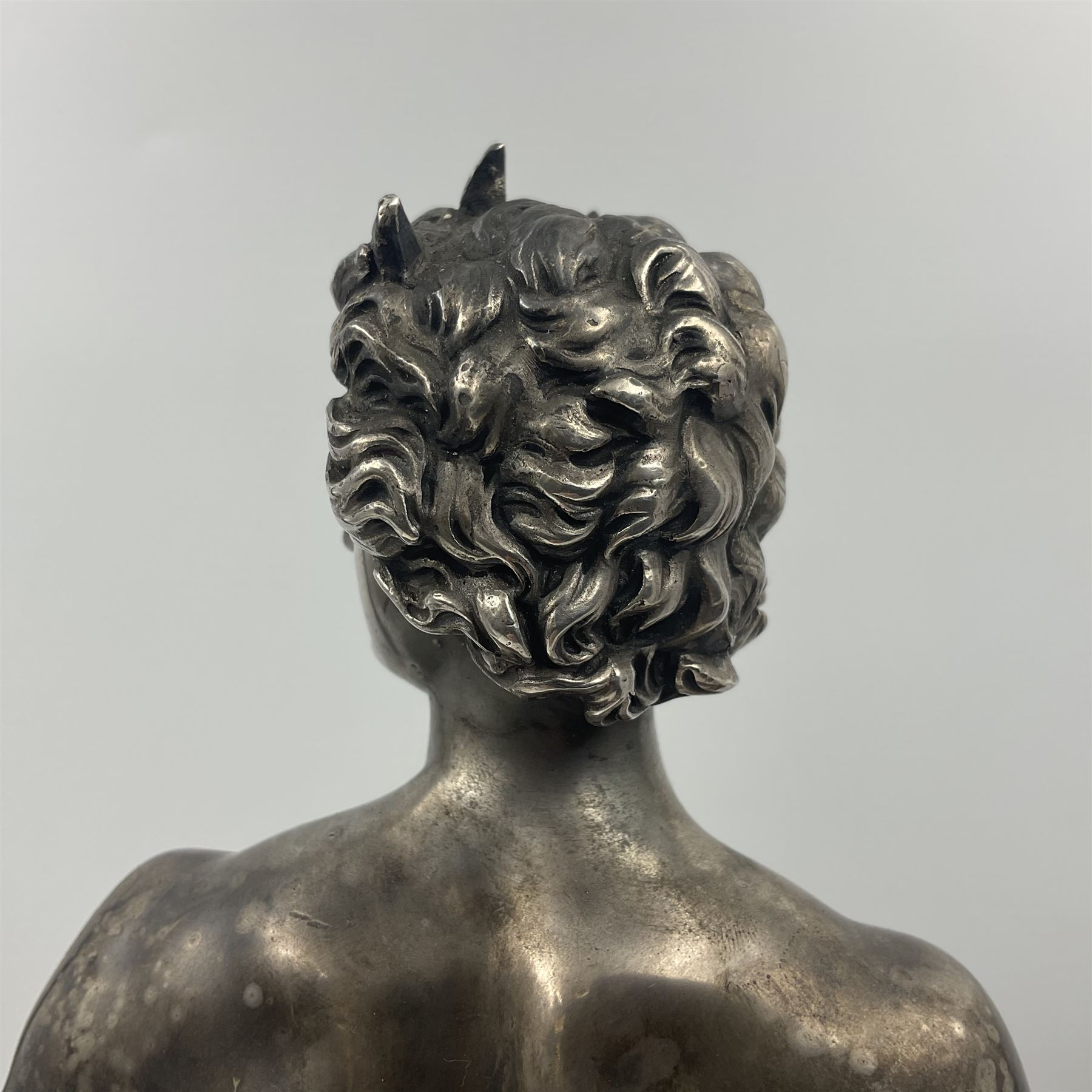 20th century silver plated figure, modelled as a classical male figure, possibly Prometheus, holding flames, one foot resting atop a small dragon, upon a circular spreading base, overall H37.5cm