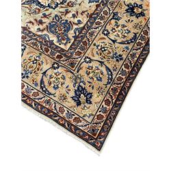Persian Kashan ivory ground carpet, floral design central medallion surrounded by trailing and interlaced leafy branches with palmettes and flower heads, matching patterned border with guard stripes 