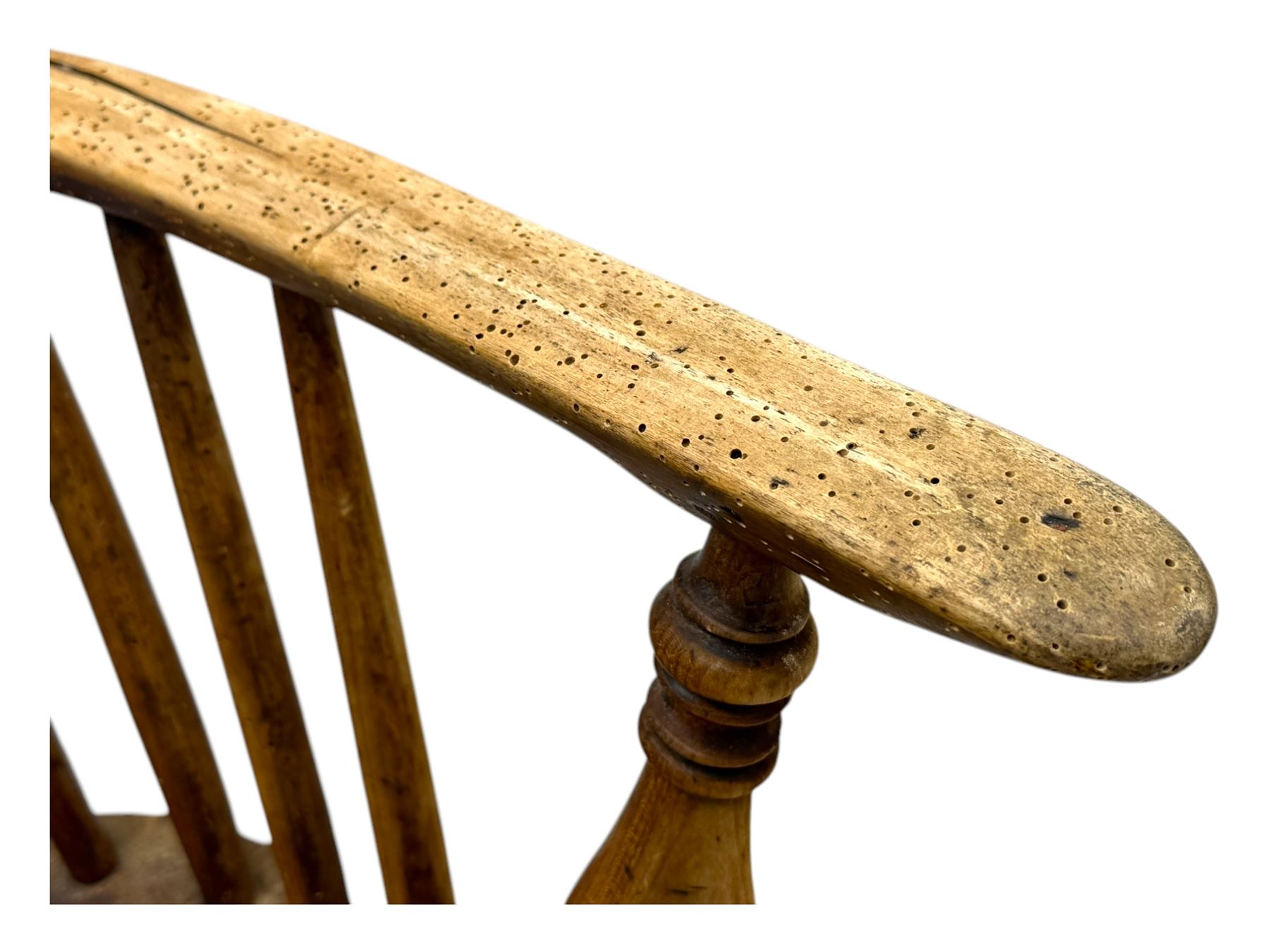 19th century provincial elm and beech Windsor armchair, shaped cresting rail over stick back with pierced and shaped splat, the dished seat on turned supports united by turned stretchers 