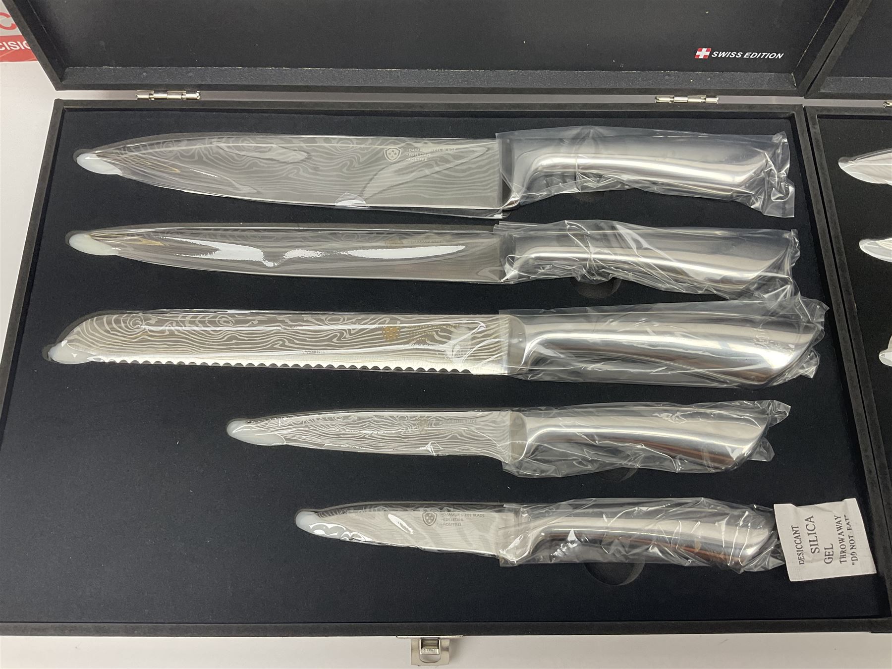Two cased Swiss knife sets