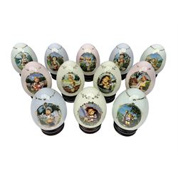 Twelve Hummel for Denbury Mint porcelain eggs, including Little Goat Herder, Merry Wanderer, Little Fiddler, Umbrella Girl etc, all with boxes and certificates