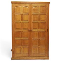 Beaverman - oak double wardrobe, enclosed by twin multi-panelled doors, Yorkshire Rose carved handles, the interior fitted with shelf and hanging rail, with signature carved beaver, by Colin Almack of Sutton, near Thirsk
