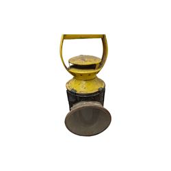 Three British Railway Bardic lamps, an enamel shunting signal disc and a yellow and black signal lamp