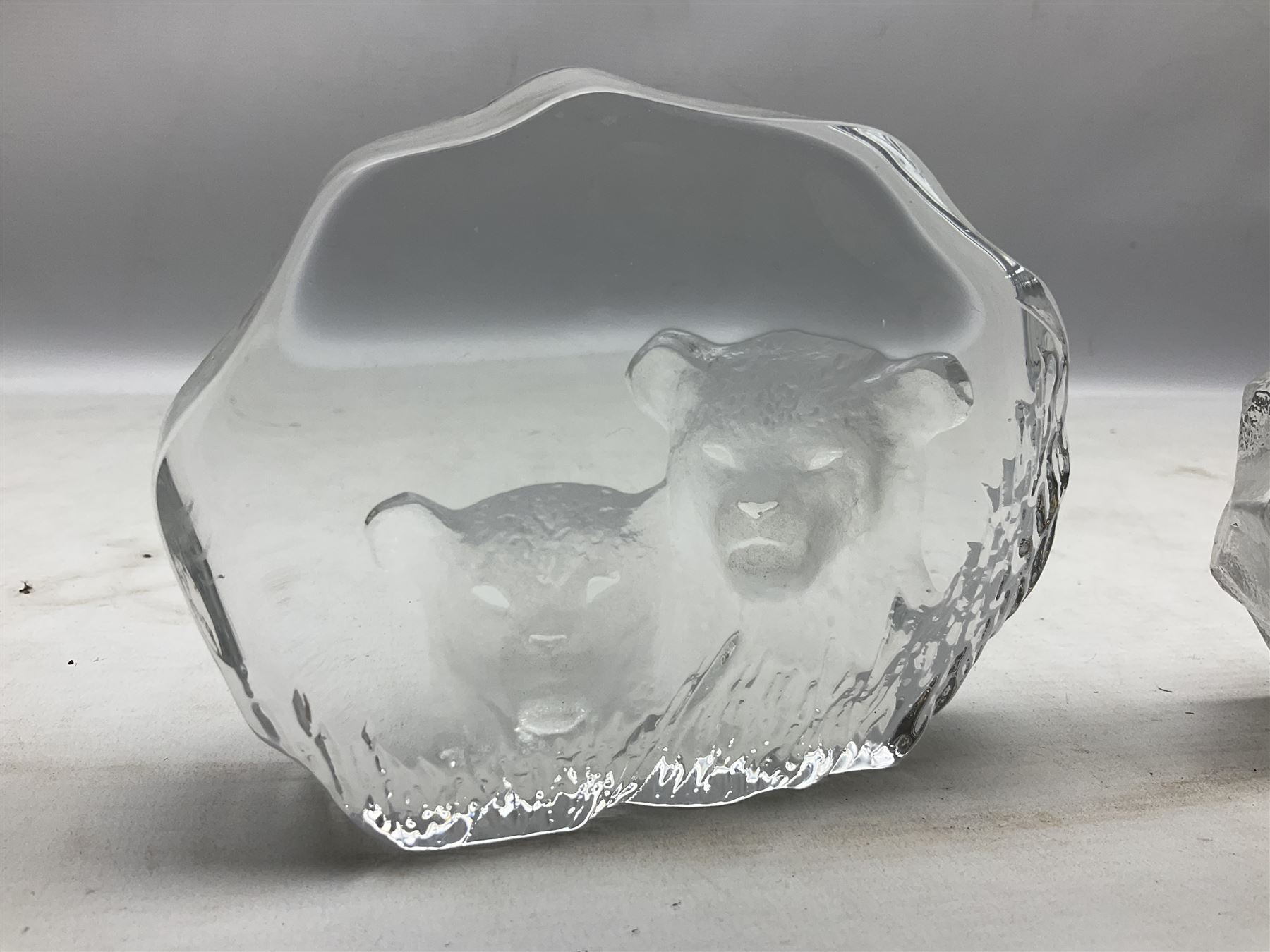 Two Mats Jonasson, Sweden paperweights, comprising polar bear in ice cave no 3152 and lion cubs, both with etched marks beneath, tallest H11.5cm