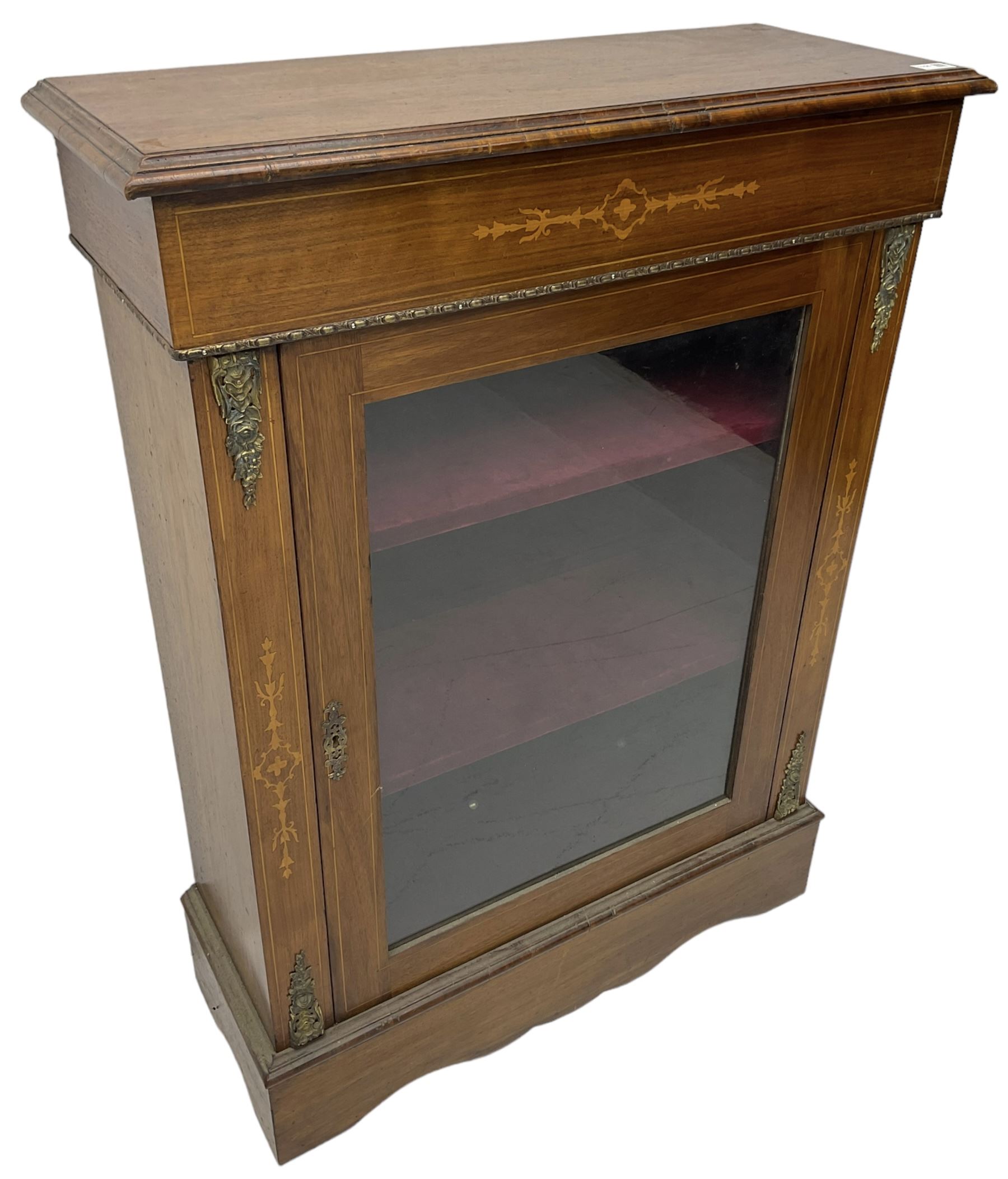 Victorian walnut pier cabinet, moulded rectangular top over inlaid frieze, decorated with gilt metal mounts and beading, the glazed single door flanked by inlaid uprights, on moulded plinth base