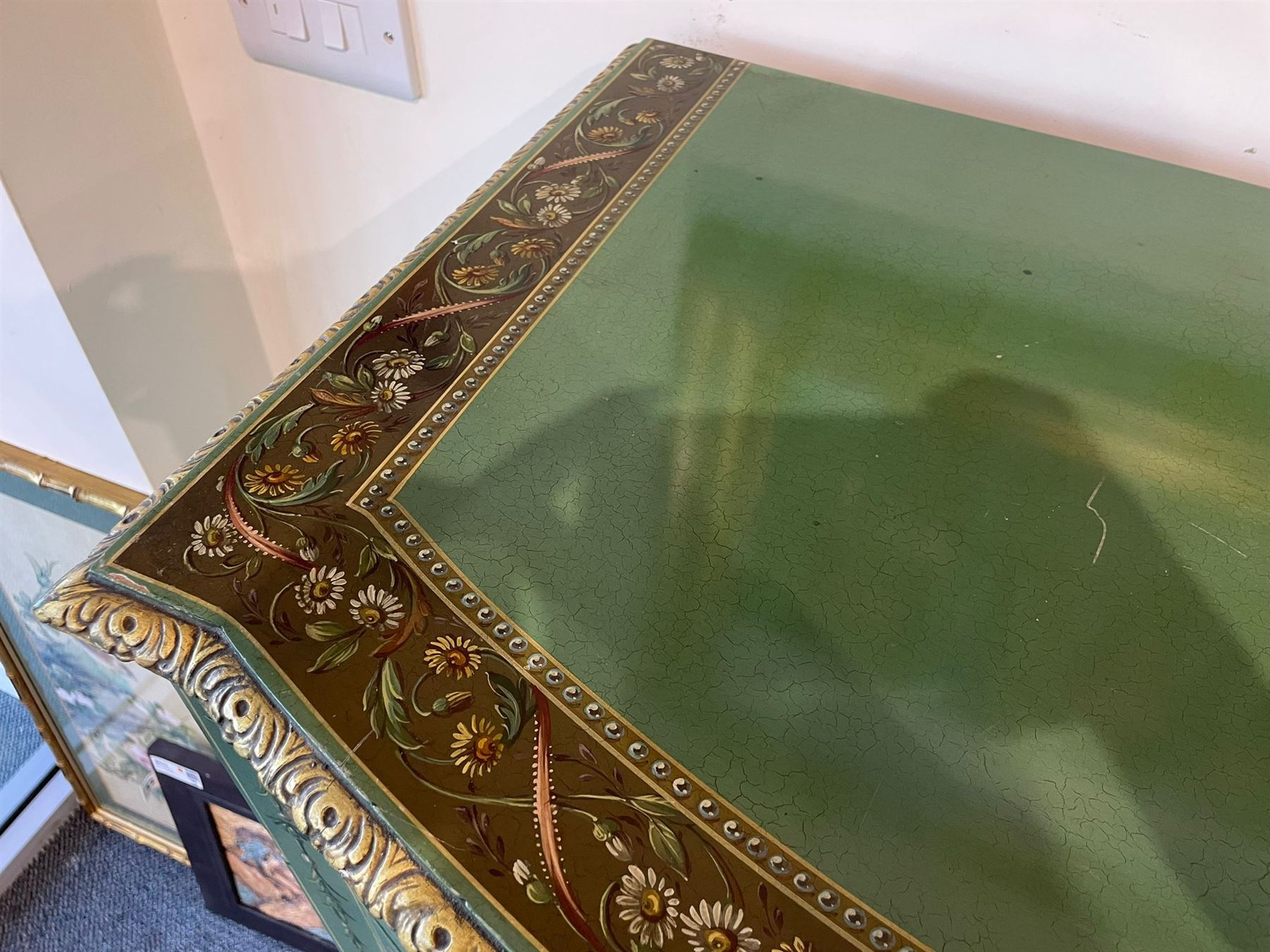 Edwardian Adam Revival green-painted and parcel gilt bowfront chest, moulded and foliate carved top painted with trailing floral band, fitted with four drawers decorated with trailing floral festoons, ribbon ties and urns, oval handle plates with engraved decoration and bead cast handles, on turned supports decorated with acanthus leaves and draped festoons 