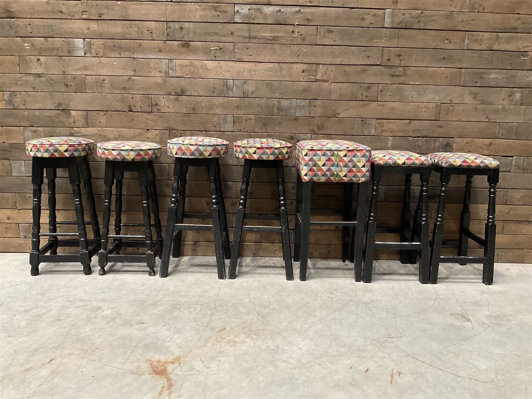 Seven tall bar stools with upholstered seat