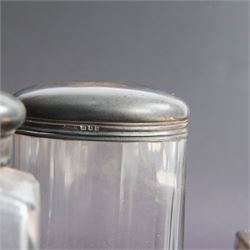 1920s gentleman's travelling case by Mappin & Webb Ltd, tan leather impressed with initials NAO, opening to reveal a compartmentalised interior containing silver mounted dressing table items, including a pair of silver mounted brushes, engraved NAO AMA 1918, hallmarked William Comyns, London 1911, five faceted glass jars and bottles with silver lids and a silver shaving brush holder, all hallmarked Mappin & Webb Ltd, London 1922, tan leather box containing razor, silver plated shoe horn, scissors and bevelled edge shaving mirror with easel support