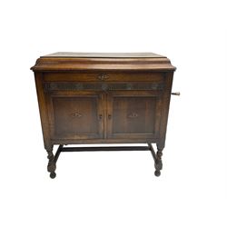 Gilbert and Co - early 20th century oak cased gramophone cabinet, rectangular hinged top concealing gramophone and storage area, fitted with two panelled cupboard doors enclosing record storage compartment and speaker