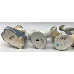  A group of Lladro and Nao figurines, comprising a trio modelled as boys playing instruments, boy with dog, boy with football, girl with puppy and kitten and a goose, (two a/f), all with printed mark beneath.   