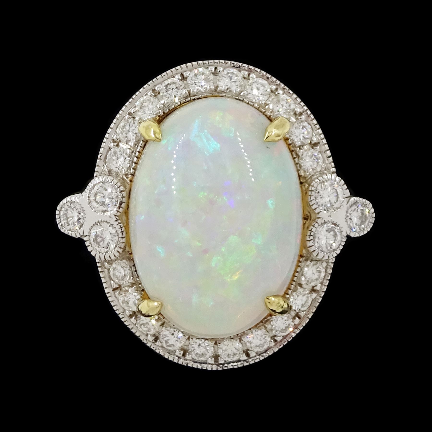 18ct white gold opal and diamond cluster ring, single cabochon cut opal of approx 5.20 carat, surrounded by round brilliant cut diamonds, in a milgrain setting, stamped 750, total diamond weight approx 0.55 carat