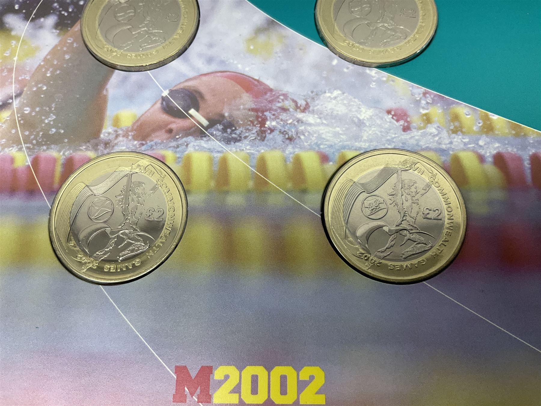 The Royal Mint Queen Elizabeth II 2002 Manchester Commonwealth Games four coin two pound coin  set in card display