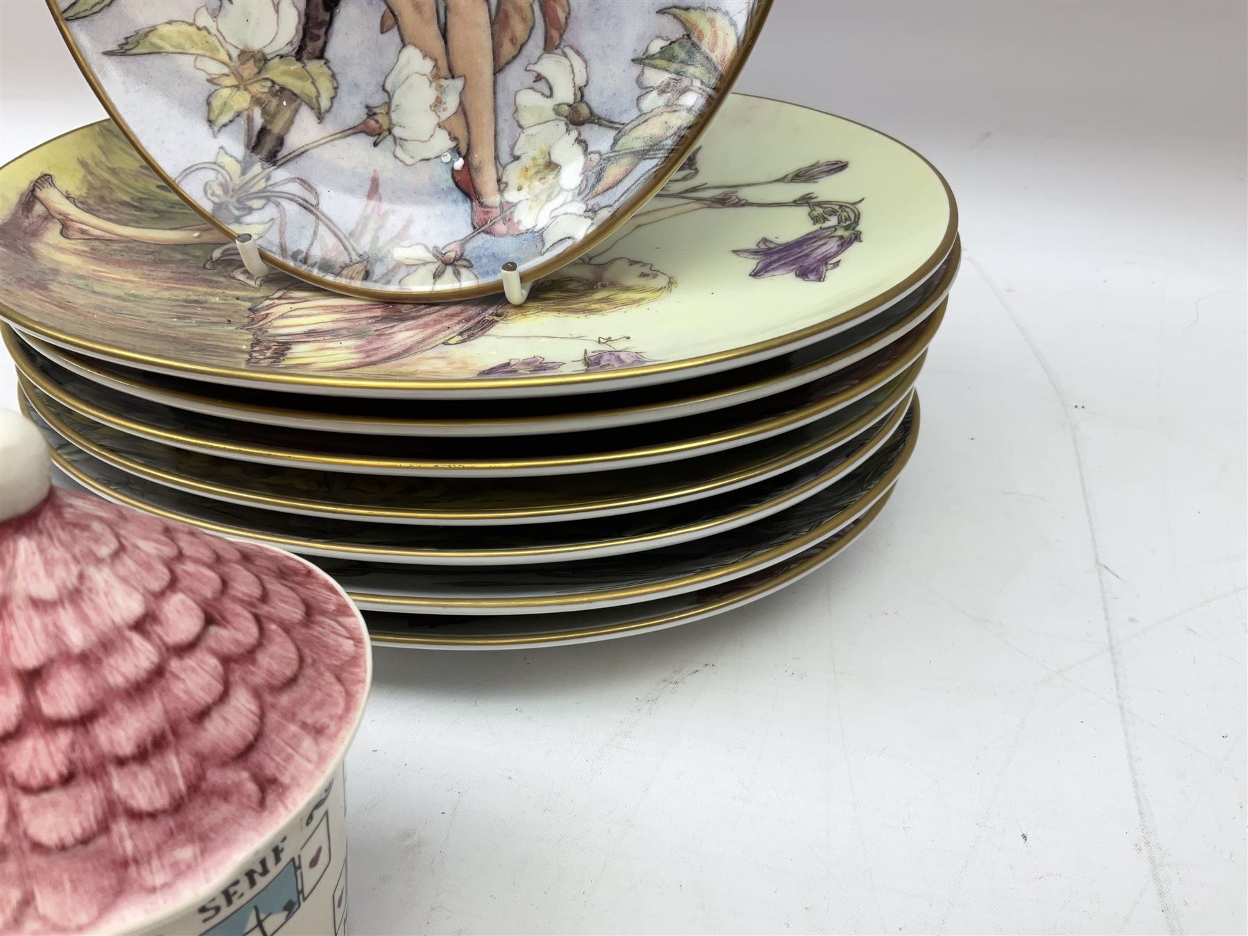 Royal Worcester Flower Fairies oval collectors plates, Goebel mustard pot, two Danbury Mint Fairy Tale bells, and pair of Hutschenreuther candlesticks decorated with scenes of Puss in Boots