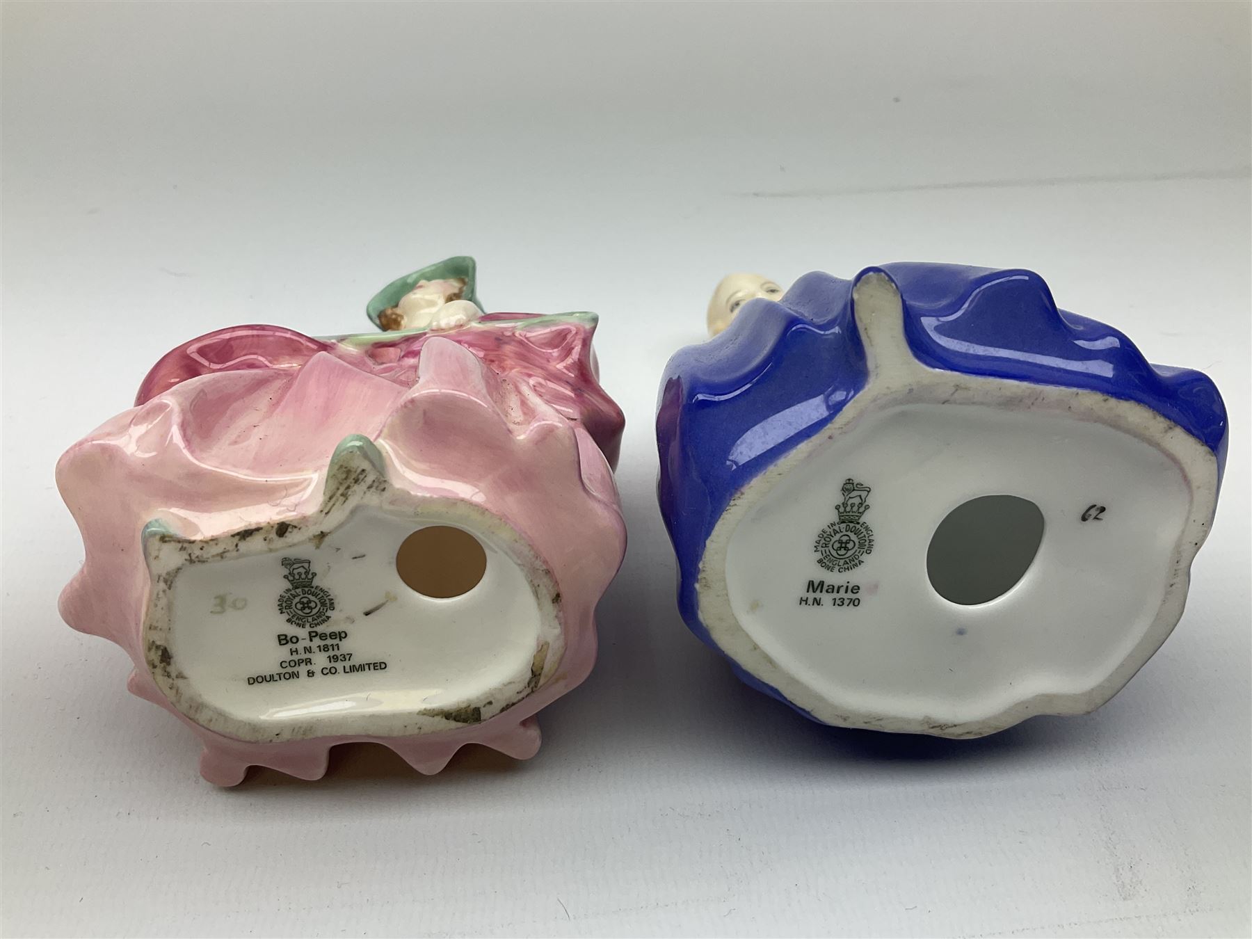 Group of figures, comprising six Royal Doulton examples, Daydreams HN1731, Silks and Ribbons HN2017, Tom Sawyer HN2926, Marie HN1370, Bo-Peep HN1811, and Tinkle Bell HN1677, together with a Dresden type 'lace' example, and a Coalport 'Swiss Cottage', (8)