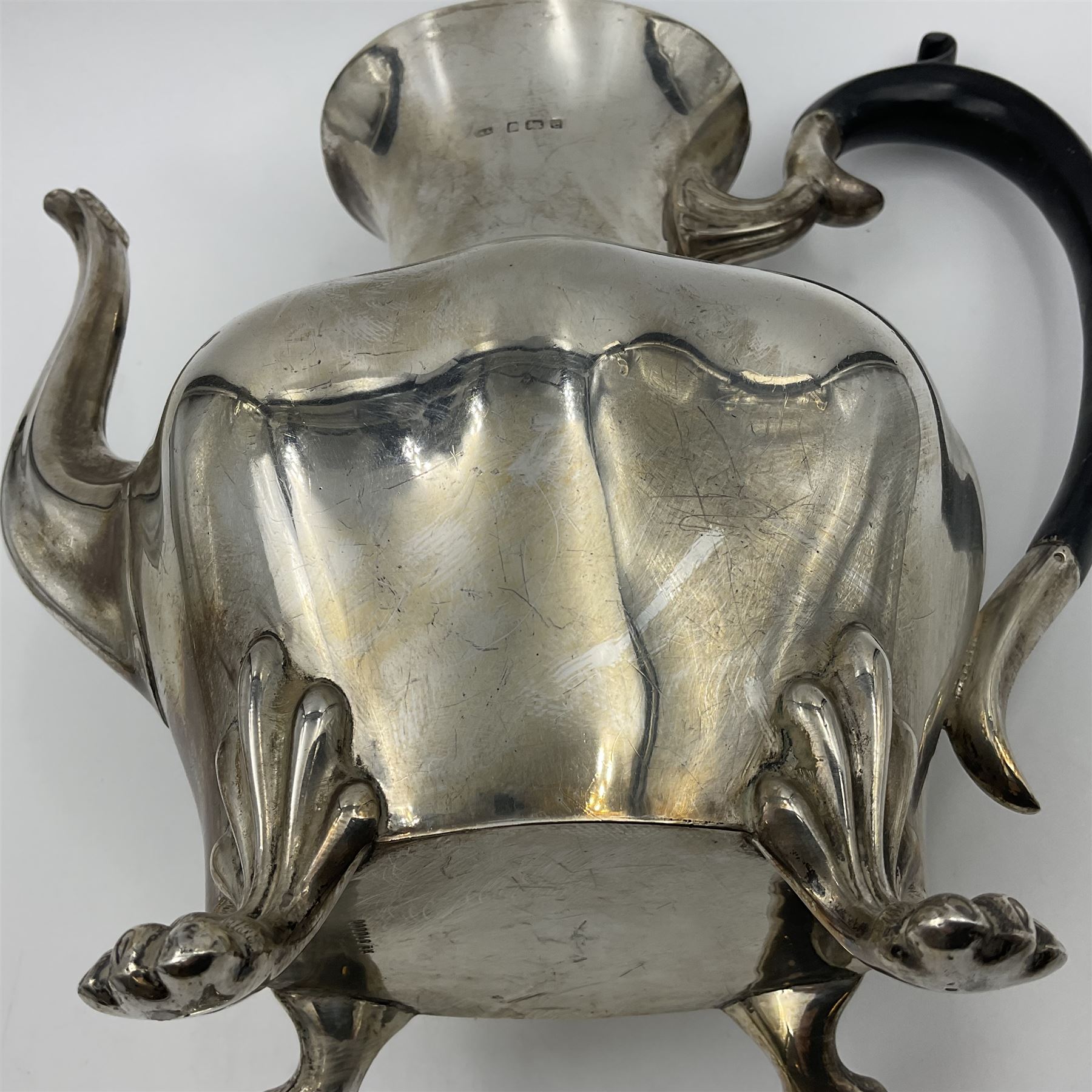 Five piece Edwardian silver tea service, comprising teapot and coffee pot, each with ebonised scroll handle, tea caddy with hinged cover, twin handled open sucrier, and milk jug, each of rounded bombe form, upon four paw feet, hallmarked William Adams Ltd, Birmingham 1904 and 1905, coffee pot H26cm
