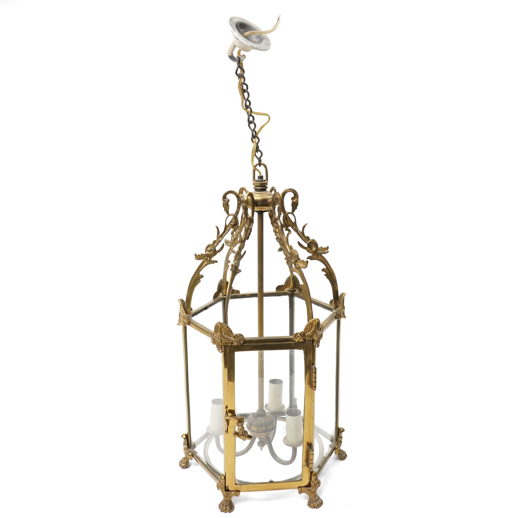 Three light hall lantern in metal and glass case, of hexagonal form, with classical decoration including a hand holding scroll handle, drop 72cm