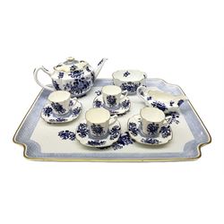 Late Victorian Coalport cabaret set for four persons, decorated with blue floral sprays and gilding upon plain ground, comprising four fluted teacups and saucers, teapot, jug and sucrier upon tray of rectangular form, all stamped with the 1851-1895 mark, L52cm
