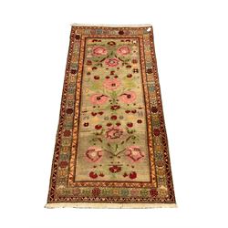 Persian design rug, the pale green field decorated with stylised flowers and geometric motifs, guarded border with repeating flower head design