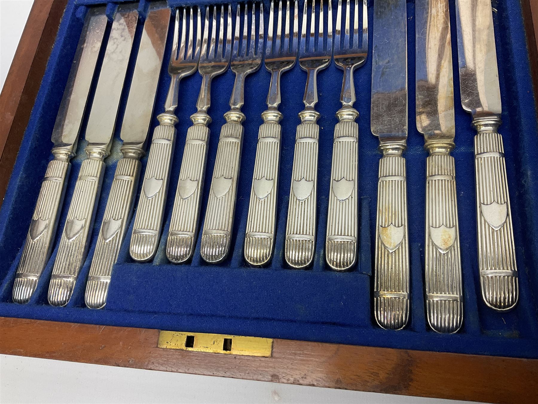 Victorian silver plated dessert set by Elkington & Co for twelve place settings, each reeded handle with vacant cartouche, each with Elkington & Co mark, date letter for 1861, and registration lozenge, contained within a mahogany case with vacant brass cartouche to the hinged cover, opening to reveal a Royal blue baize lined interior with removable tray, case H6cm W29.5cm D26.5cm