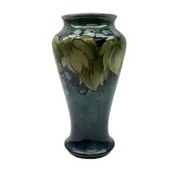 Moorcroft Grape and Leaf pattern vase, of tapering form, on green and blue ground, with impressed and painted mark beneath, H23cm