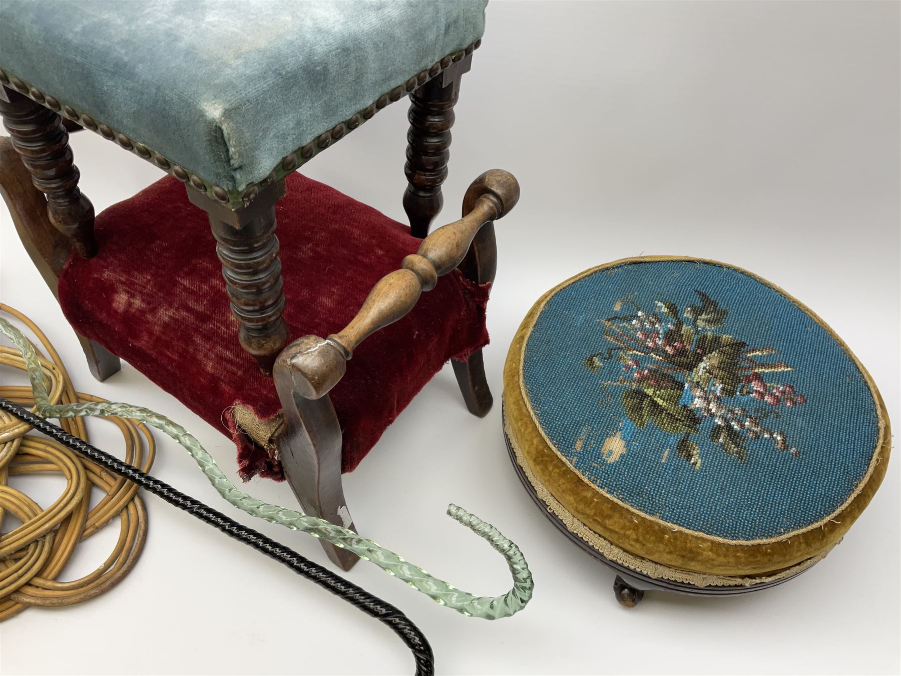 Victorian beadwork footstool with two other wooden upholstered footstools, one with turned bobbin legs, two Victorian glass frigger canes, one of twisted spiral form, and three carpet beaters