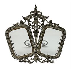 Early 19th century silver plated double photograph frame, each rounded rectangular aperture surrounded by a paste border, with ornate scroll feet and mantling also set with clear paste stones, with easel style support verso, H12cm