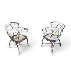 Pair of late 19th century painted cast iron garden chairs, open scroll and heart backs, ornate circular seat, raised on cabriole legs with X stretcher