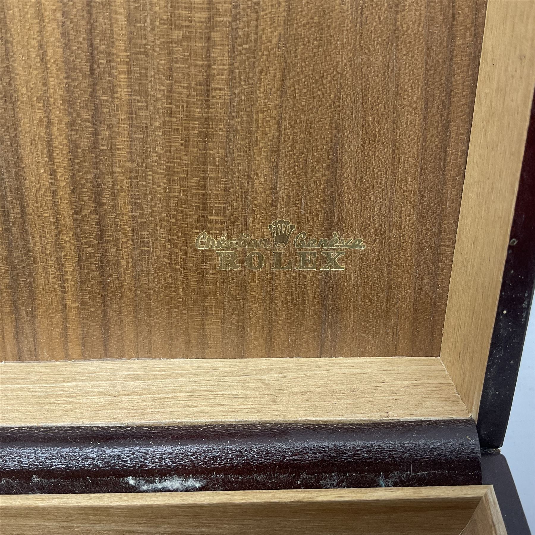 Rolex brown leather box, with decorative buckle to cover, opening to reveal wooden veneer interior, the inside lid stamped in gilded lettering 'Creation Genève Rolex', stamped beneath 'Montes Rolex S.A. Geneve Swiss 71.00.04, H8cm