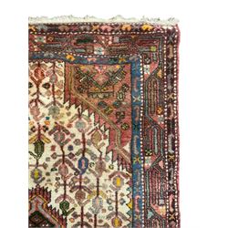 Small Persian rug, ivory and pale red ground, decorated with central medallion within a field of trailing Boteh motifs, geometric design guarded border