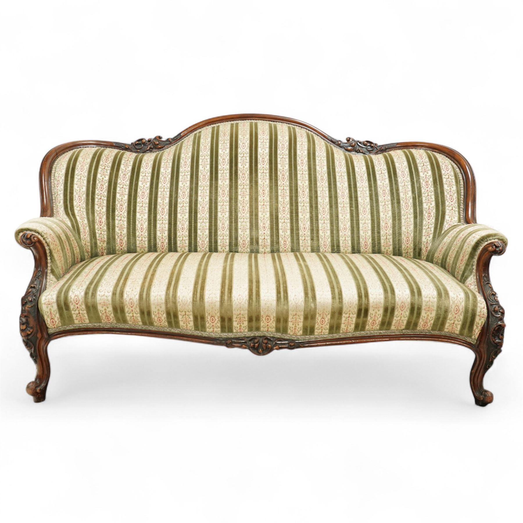 Victorian walnut framed salon sofa, the shaped back and scroll arms with carved floral detail, upholstered in green and cream striped fabric, raised on scrolled cabriole legs 