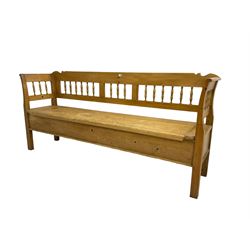 Pine bench, spindle back over hinged box seat, raised on square supports