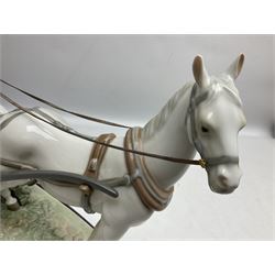 Large Lladro figure, The Landau Carriage, modelled as a horse drawn open top carriage, on a mahogany base, no 1521, sculpted by Juan Huerta, year issued 1987, year retired 1998, H30cm 