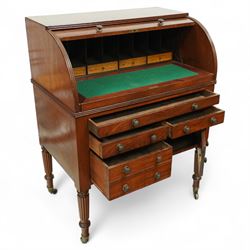 Regency period mahogany cylinder desk, the roll-top enclosing a fitted satinwood interior with pigeonholes and drawers, sliding green baize writing surface, lower section fitted with four drawers and a cupboard, on reeded tapering legs with brass caps and castors