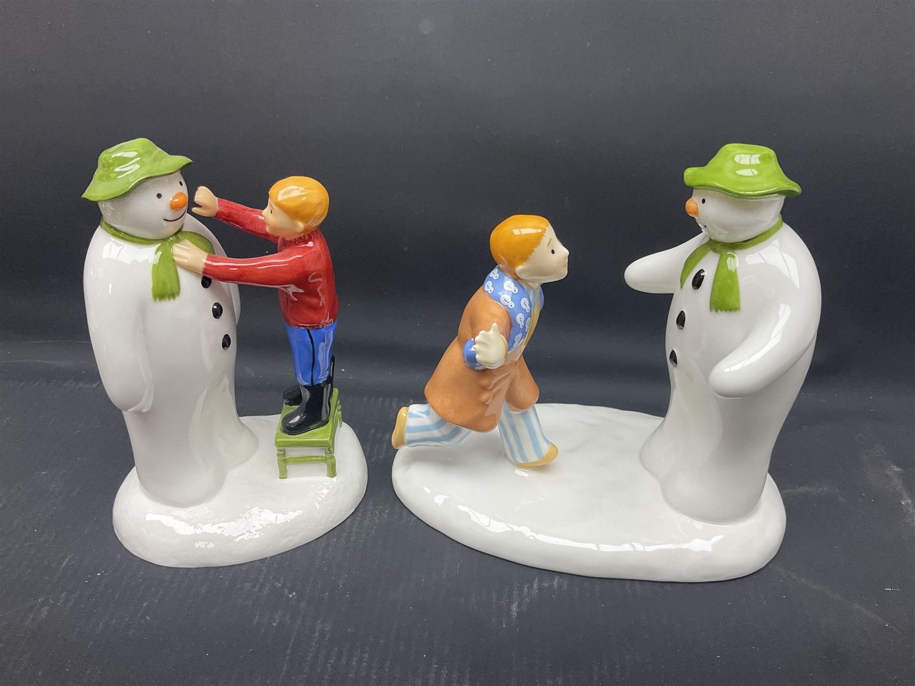 Four Coalport Characters The Snowman figures, comprising I'll Never Forget you with certificate, Pulling a Cracker and Adding a Smile, all with original boxes