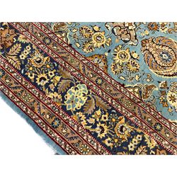 Central Persian Qum pale blue ground rug, the field decorated with stylised plant motifs surrounded by trailing foliate vine patterns in a symmetrical format, the multi-band guarded indigo border decorated with repeating flowerheads 