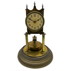 An anonymous early 20th century German 400-day torsion clock, with a circular enamel dial, upright Arabic numerals and minute track, spade hands under a glass shade, circular rotating pendulum with regulation, on a circular brass base with adjustable feet. 
H33cm
