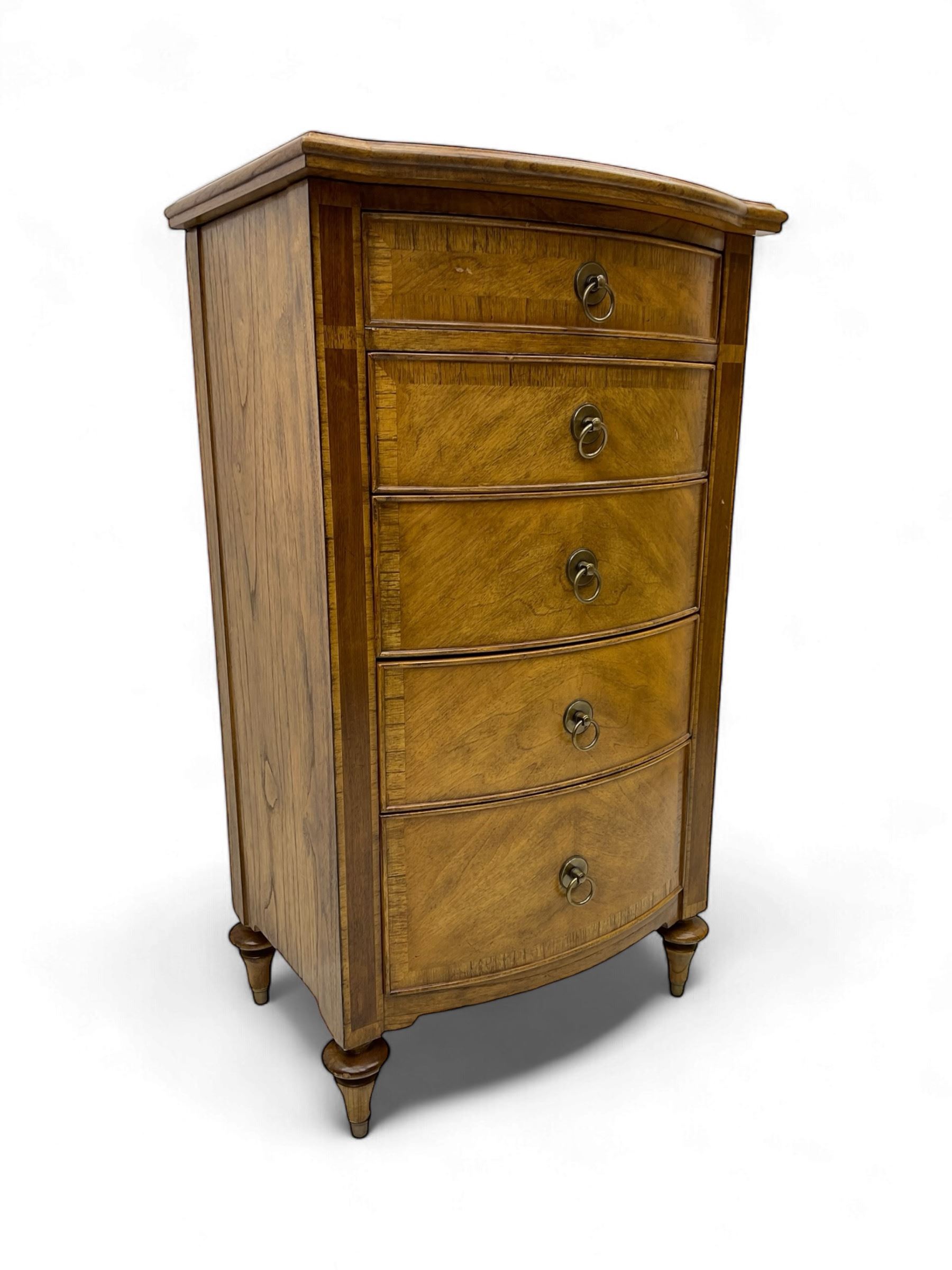 Frank Hudson - mid-20th century Mindi ash and burr walnut bow-fronted lingerie chest, crossbanded hinged top concealing vanity mirror, over five graduated cockbeaded drawers, raised on turned supports