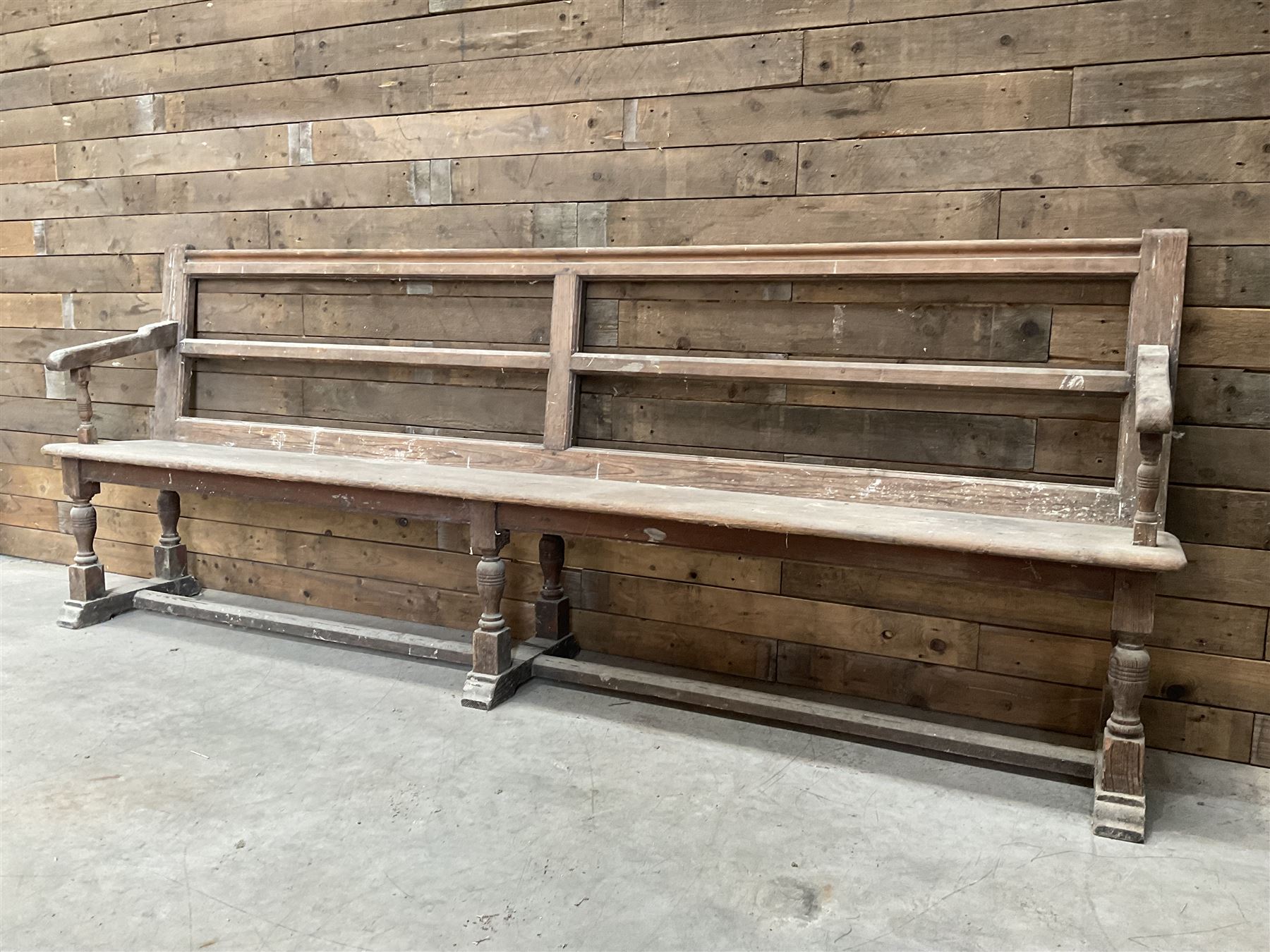 Victorian pitch pine bench pew, turned arms and legs, rail back with plank seat, 249cm