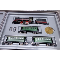  Marklin HO gauge - 1985 50th anniversary commemorative pack containing two individually boxed sets - 0-4-0 tank locomotive 'Marklin' No.00-50D freight set with three items of rolling stock and 0-4-0 electric locomotive with pantographs and three passenger coaches, each with commemorative medallion and certificate, boxed  