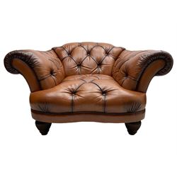 Tetrad - 'Oskar' armchair, Chesterfield shape with rolled arms, upholstered in buttoned tan leather, on turned and reed moulded feet 